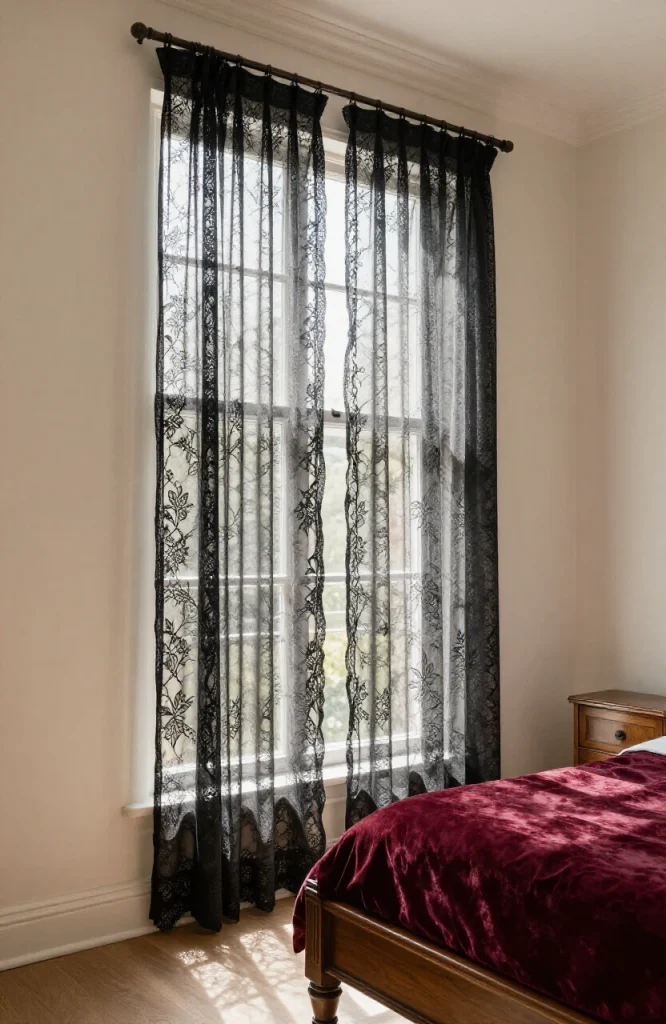 Black lace panels layered inside window frame creating gothic romantic detail for Halloween bedroom decoration