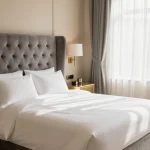 Modern luxurious bedroom featuring elegant furnishings, soft lighting, high-quality bedding, and designer decor elements